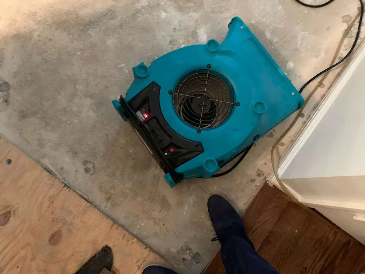 Air mover drying subfloor during Commercial Water Damage Restoration in Timberwood Park
